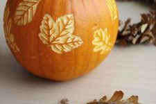 a pumpkin with carved leaves is a beautiful all-natural fall decoration you can make yourself