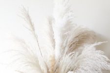 a vase with white pampas grass is a trendy and chic decoration for the fall and not only