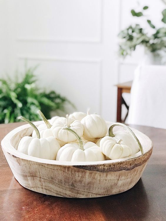 a wooden bowl with white pumpkins is a cool decoration or a centerpiece that you can make very fast