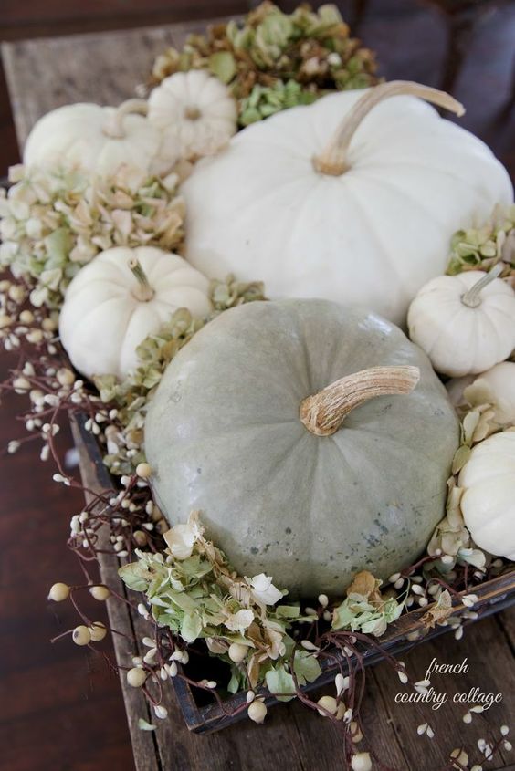 a wooden tray with greenery, blooming branches and neutral pumpkins is a natural and chic fall centerpiece or arrangement