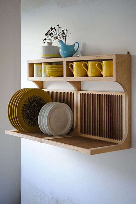 an elegant wooden shelf for storing plates and mugs and cups at the same time is perfect for a modern kitchen