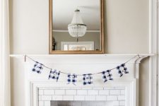 blue, navy and white painted and stenciled pumpkins and a plaid garland will bring a non-traditional touch of color and print to the space