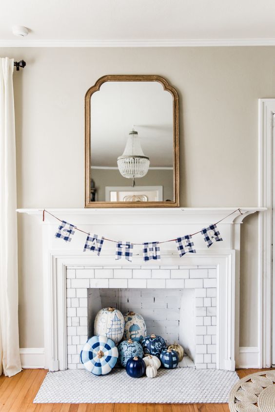 blue, navy and white painted and stenciled pumpkins and a plaid garland will bring a non-traditional touch of color and print to the space