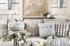 chalk paint pumpkins, greenery and white blooms to create a vintage farmhouse space with neutral decor