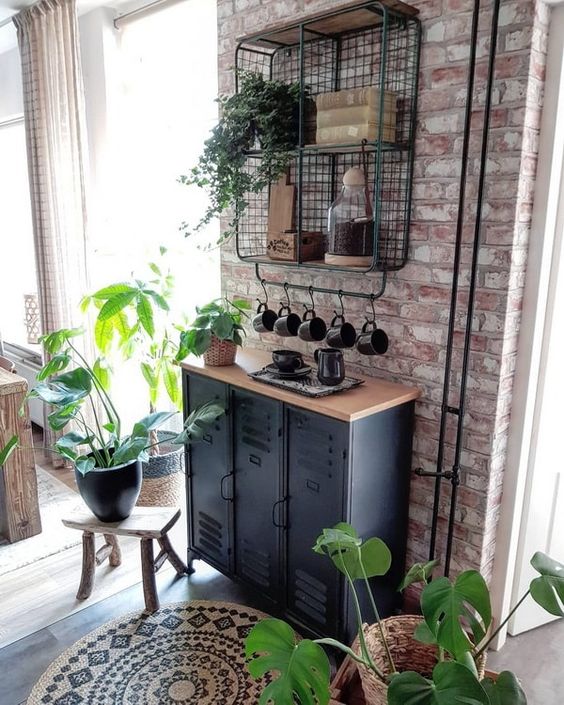 industrial black metal cabinets with a wooden countertop and a wire open shelf on the wall for storage