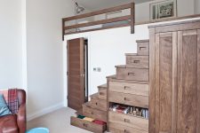 ingenious small bedroom design where under bed storage is take to another level with drawer-stairs and a matching wardrobe