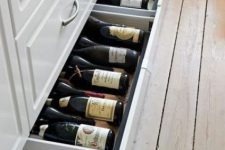 large flat drawers in the lower part of the kitchen island are great for storing wine and other drinks that don’t require fridges