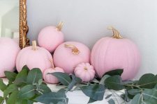 light pink pumpkins with gilded stems and lots of greenery will make the mantel look super glam and fall-like