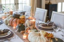 natural fall table decor with candles, pumpkins, blooms and tree stumps and branches is a cool idea for the fall