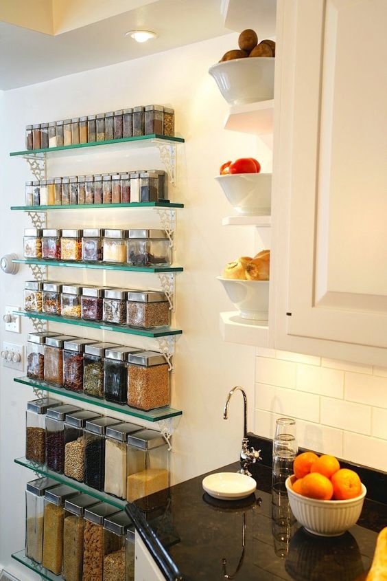 open glass shelves for storing spices and other food in containers and some open shelves on the side of the cabinet