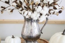 white pumpkins, pinecones and a cotton arrangement in a silver jug for elegant and chic fall decor