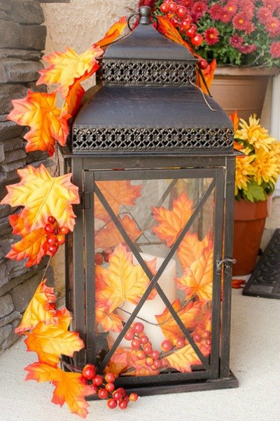 A garland made of faux autumn's leaves and berries is a really easy way to decorate a lantern and to add a touch of fall here and there.