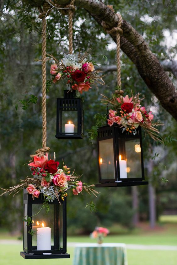 It's a quite popular idea to use lanterns with candles for wedding decor. Little bouquets of fall blooms on top of them would be great way to personalize them.