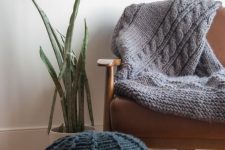 a black knit pouf and a grey knit blanket are a great solution to cozy up your space and make it fall-ready