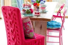 a chair covered with hot pink knit looks super bright and cozy and will make your space very welcoming