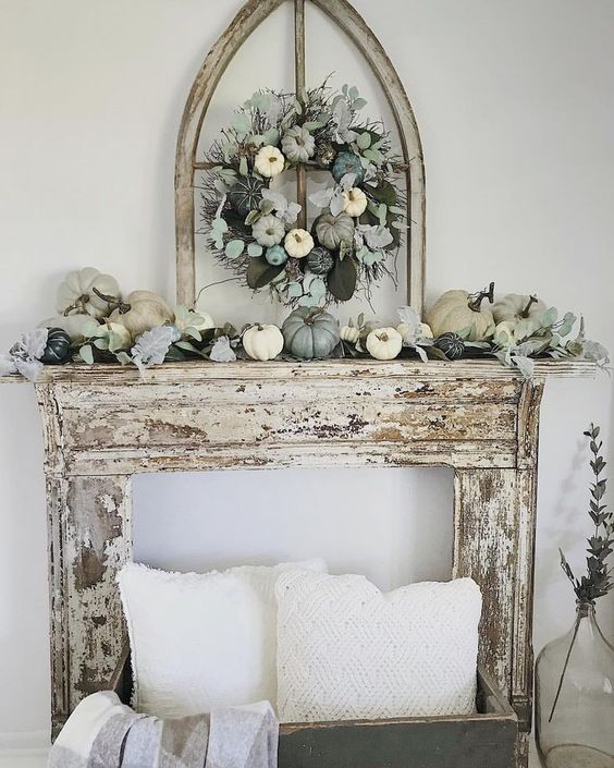 a chic neutral and pastel fall mantel with a faux pumpkin and greenery wreath and the same on the mantel