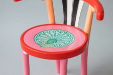a colorful chair with pink and red seat, with a red back and black and white stripes is a lovely idea for a quirky space