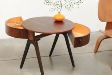 a creative round rich-stained mid-century modern coffee table on tall legs and with semi circle drawers is a very stylish idea