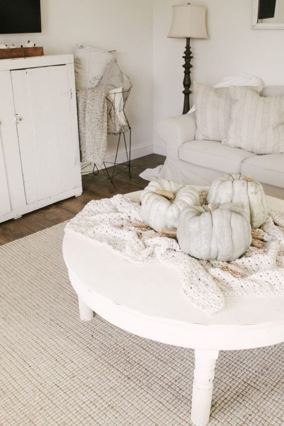 a crochet blanket and some large heirloom pumpkins on it are amazing for fall home decor