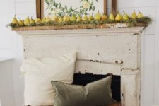 a harvest fall mantel with moss, pears and a cool sign plus muted pillows on wooden boxes