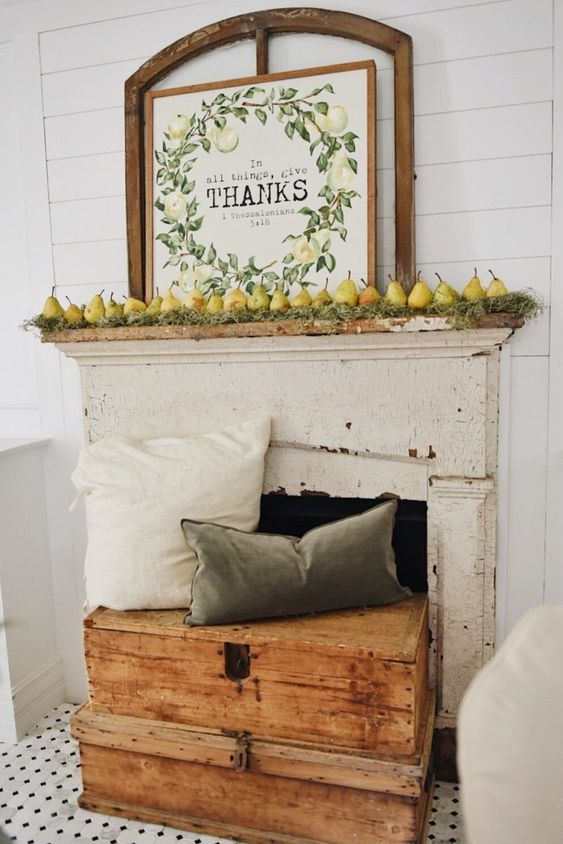 a harvest fall mantel with moss, pears and a cool sign plus muted pillows on wooden boxes