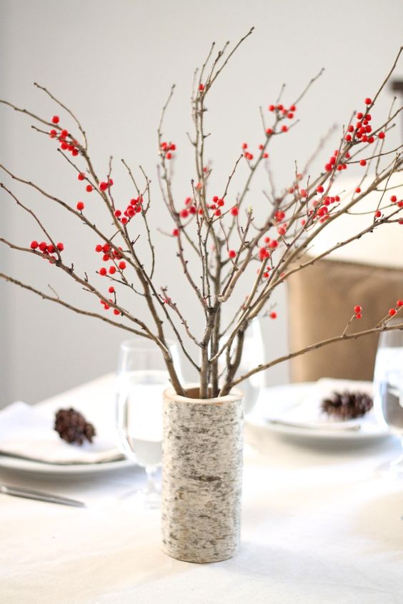 A large branch imitating vase with branches and berries is a simple contemproary centerpiece for the fall