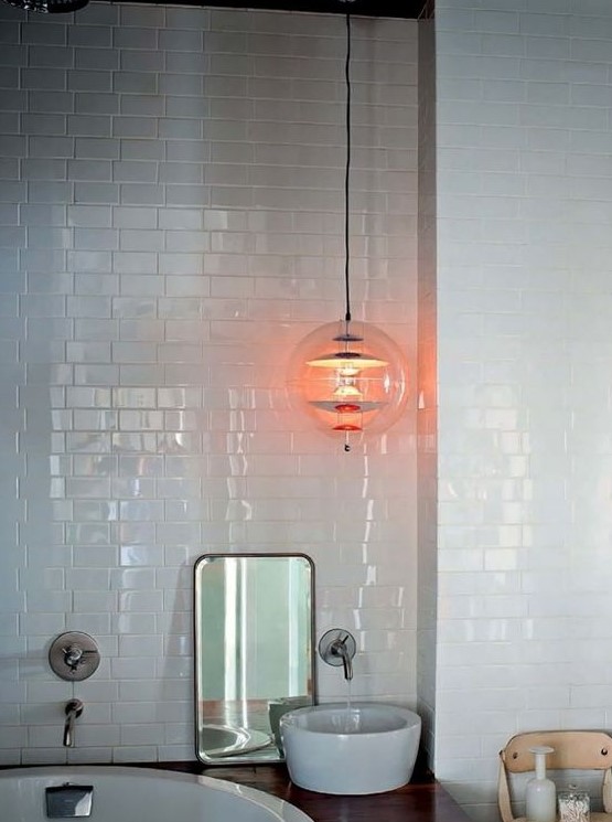 A large pendant lamp of clear glass and metallic touches will accent any bathroom making it more eye catchy