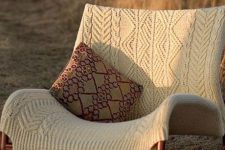 a lounger covered with a neutral patterned piece is a great way to style a chair for the cold season