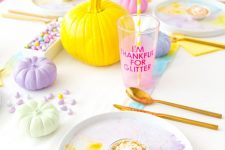 a lovely and bright pastel fall tablescape with pastel pumpkins, candies, marbled dishes and bold table runners