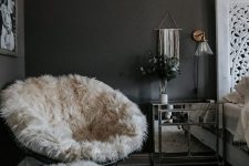 a papasan chair finished off with a white faux fur cover and a matching stool with such a cover for cold months