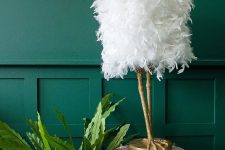 a refined and quirky table lamp of white ostrich feathers and gold leg-shaped base is a very fun idea