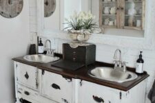 a shabby chic vanity space with adorable vintage pendant lamps over the vanity that add a refined touch