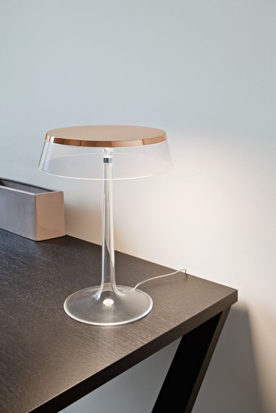 a super elegant and ultra-minimalist clear and copper table lamp with a flat lmpshade is very stylish and bold
