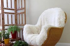 a vintage wicker chair with white faux fur is a stylish piece for a boho chic space or a rustic one
