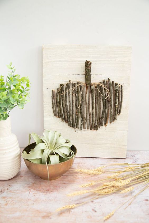 an artwork of a pumpkin done with twigs and branches is a cute DIY for this fall