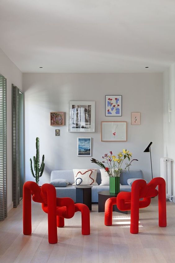 bold red wrapped and bent chairs composed each of a single piece of upholstery look super cool and accent the space