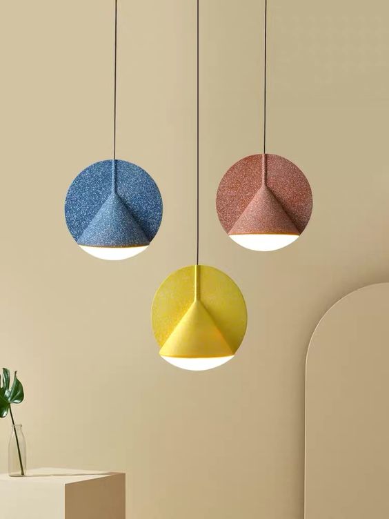 Colorful felt pendant lamps with circles and cone shaped bulbs are amazing to spruce up a modern space