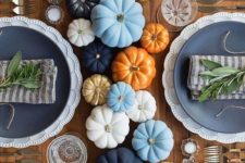 colorful painted pumpkins for a cool table runner, fresh twigs for each place setting and some candles