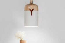 this pendant lamp has a cool bottle-resembling design and is made of a unique blend of materials, which aren’t characteristic for lamps