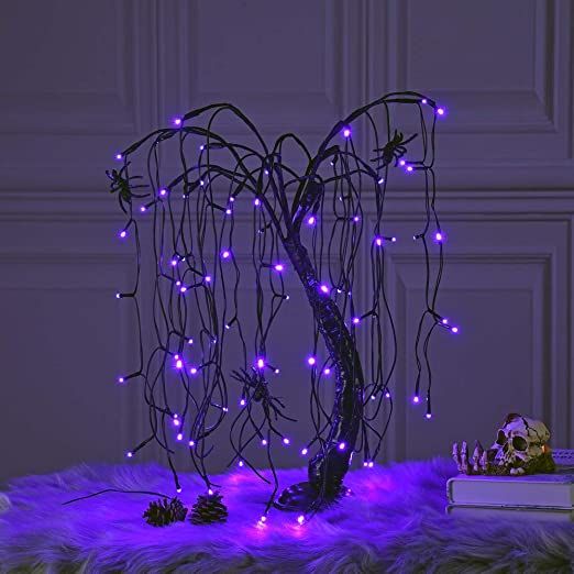 a Halloween willow tree with purple lights and spiders is a unique idea to style your home for Halloween