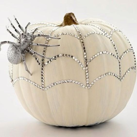 a sparkling pumpkin with rhinestones and a a silver spider for a glam feel is a pretty solution for Halloween