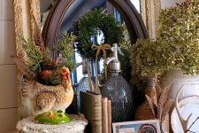 a vintage Thanksgiving mantel with dried berries, blooms, green hydrangeas, a turkey planter and some cards and books