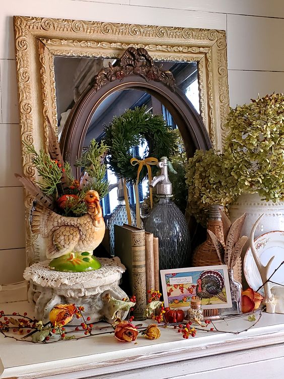 a vintage Thanksgiving mantel with dried berries, blooms, green hydrangeas, a turkey planter and some cards and books