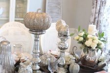 a vintage Thanksgiving table with mercury glass stands, silver glitter pumpkins, turkey, white blooms and pink and white porcelain