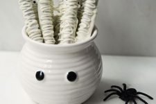 a white bowl with googly eyes and white sweets with eyes is a cool idea for a Halloween kids’ party in neutrals