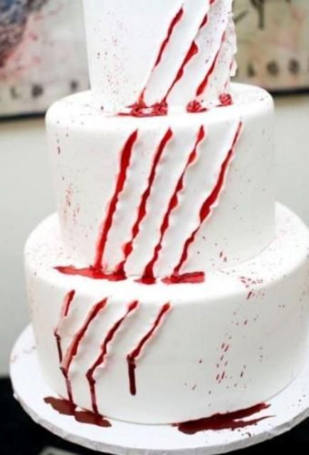 a white cake with scratches and bloody dirpping is a perfect solution for any kind of Halloween party