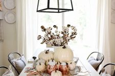 a white fall and Thanksgiving centerpiece of white pumpkins, cotton, copper mugs and a letter banner