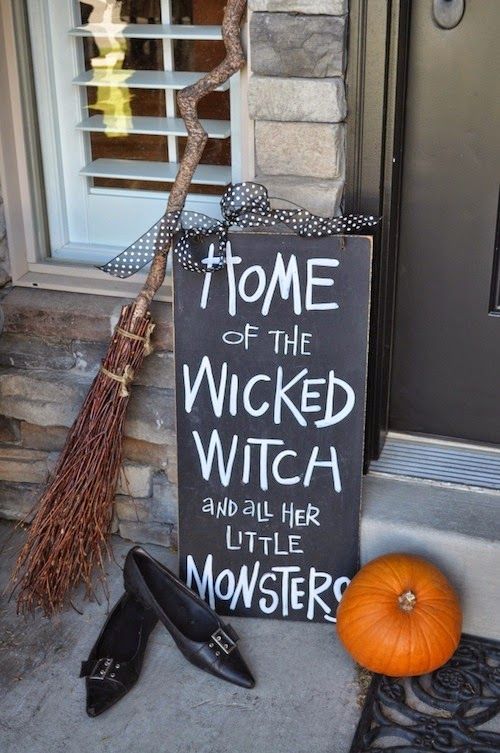 easy front porch Halloween styling with a pumpkin, a chalkboard sign, a broom and witches' shoes
