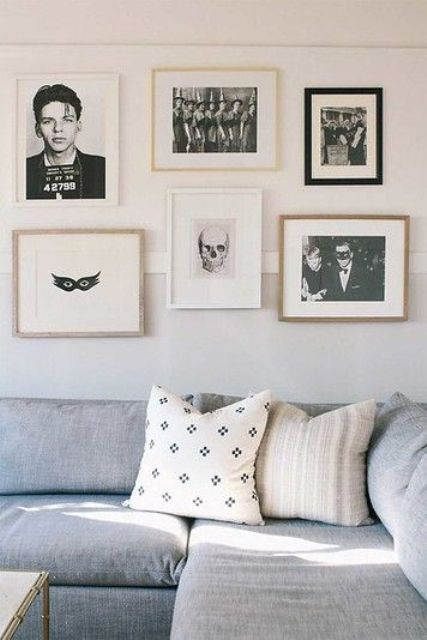 minimalist Halloween decor - a gallery wall of black and white scary pics that is amazing for non-tacky styling