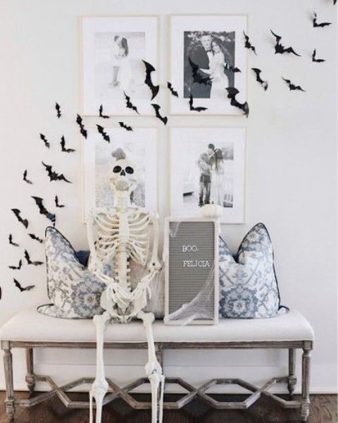 minimalist Halloween decor with black paper bats on the wall and gallery wall, a skeleton, a mini sign is lovely for minimal spaces